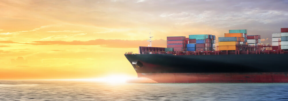 Container,Cargo,Ship,In,The,Ocean,At,Sunset,Sky,,Global